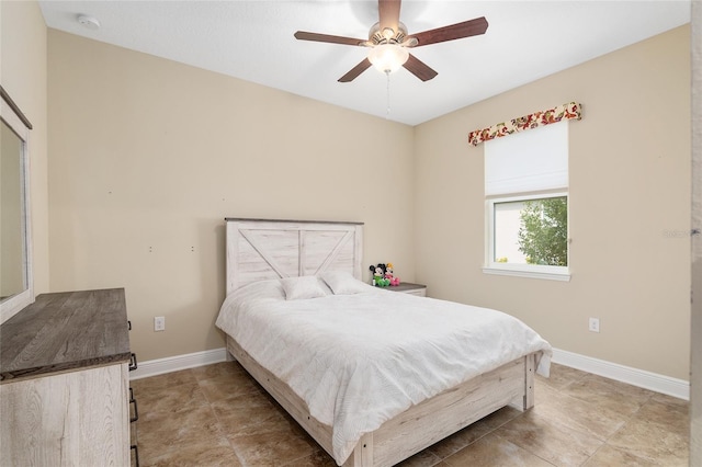 tiled bedroom featuring ceiling fan