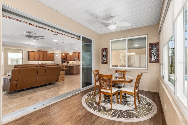 sunroom / solarium with wooden ceiling and ceiling fan