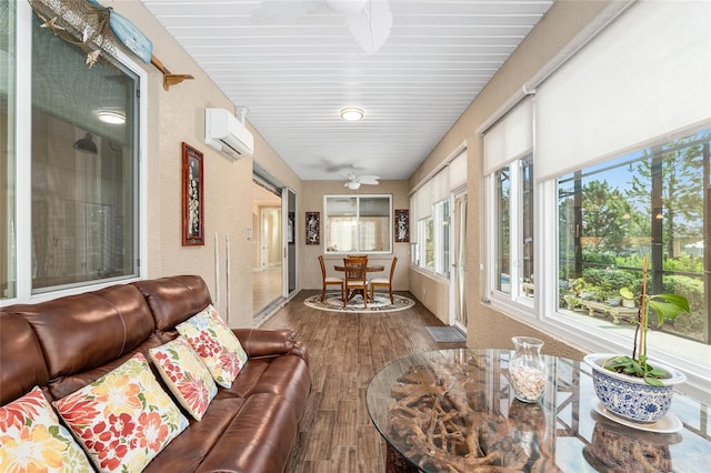 sunroom featuring an AC wall unit and a wealth of natural light