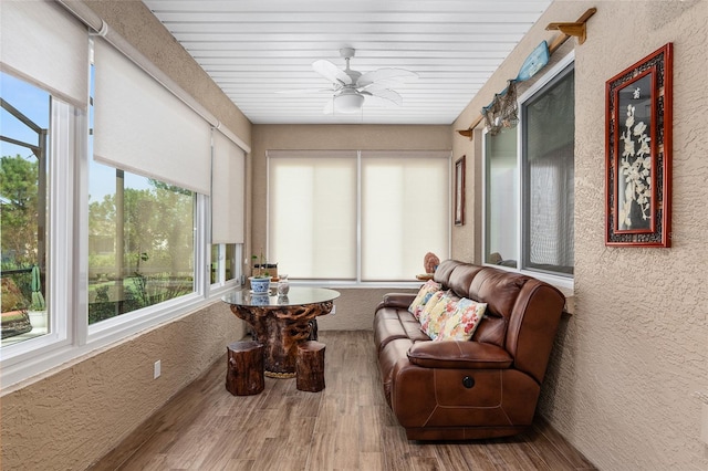 sunroom with ceiling fan and wood ceiling