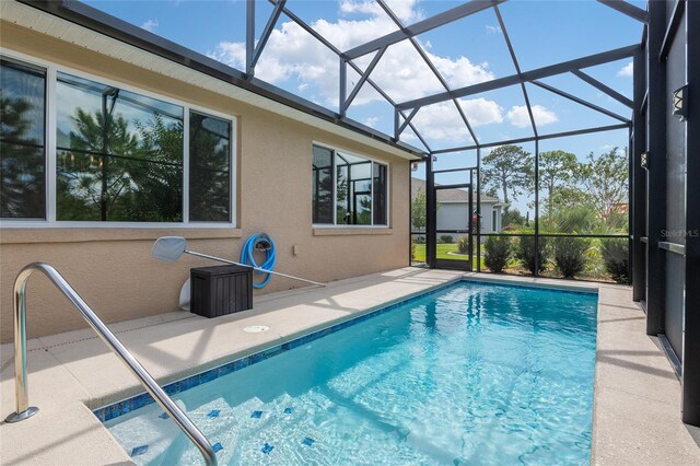 view of swimming pool featuring a patio area and a lanai