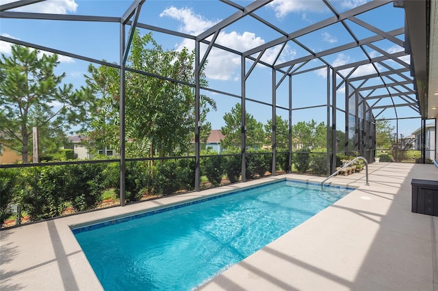 view of pool featuring glass enclosure and a patio area