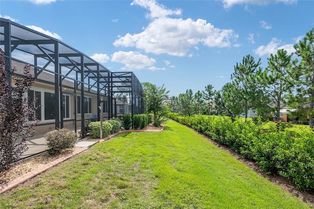 view of yard with glass enclosure