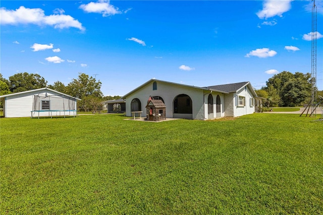 rear view of house with a yard