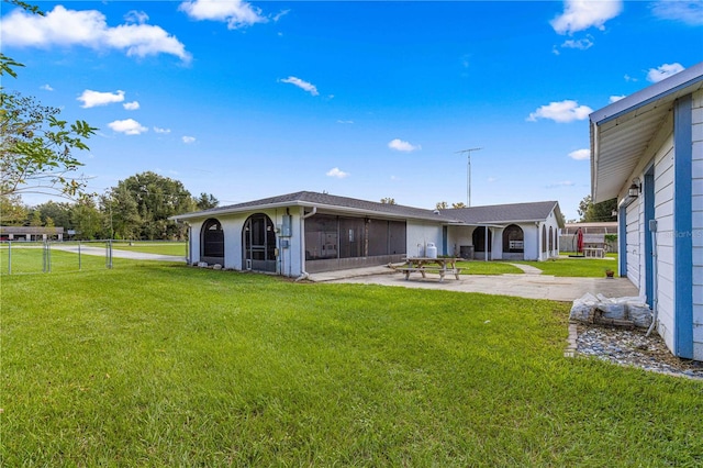 back of house with a yard and a patio area