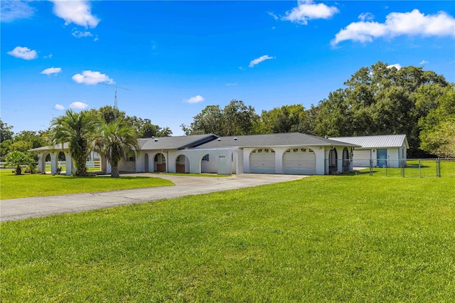 single story home with a garage and a front lawn