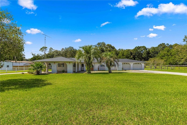 ranch-style home with a garage and a front lawn