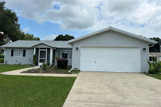 single story home featuring a garage, a front yard, roof with shingles, and driveway