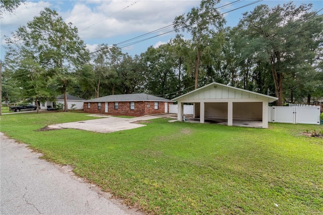 ranch-style house featuring a front yard and a carport