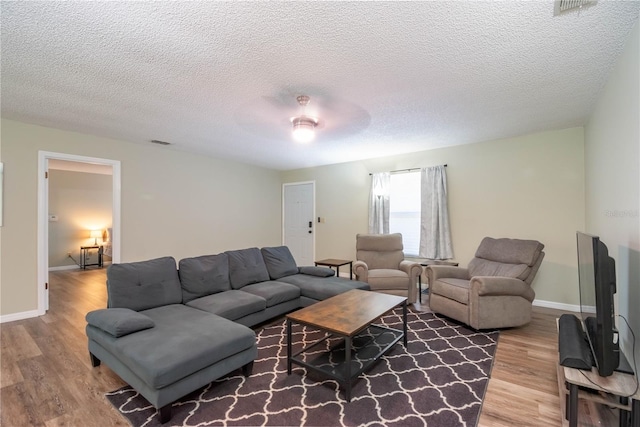 living room with wood-type flooring and a textured ceiling