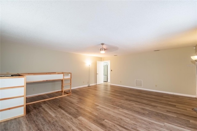 unfurnished room with ceiling fan and hardwood / wood-style floors