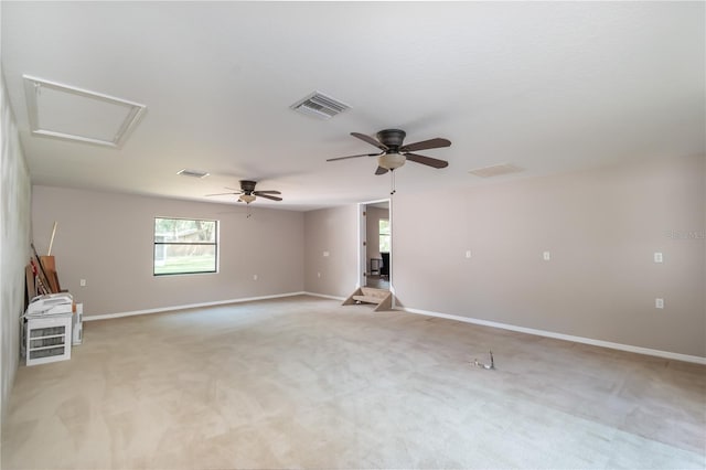 empty room with ceiling fan and light carpet