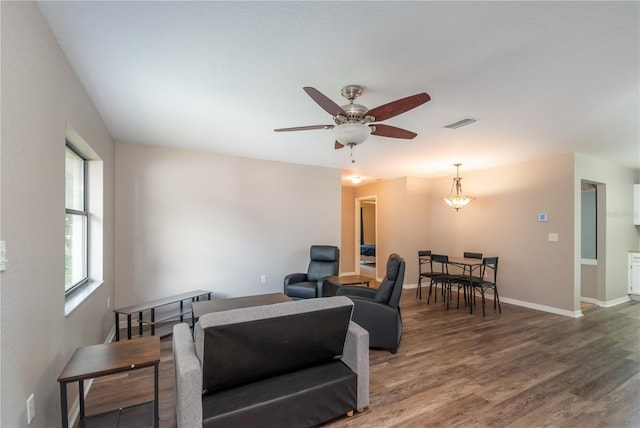 living room featuring ceiling fan and hardwood / wood-style flooring