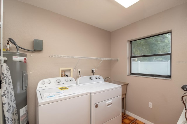 laundry room featuring separate washer and dryer, electric water heater, and tile patterned floors