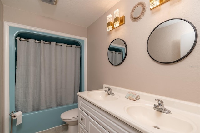 full bathroom with shower / bath combination with curtain, vanity, toilet, and a textured ceiling