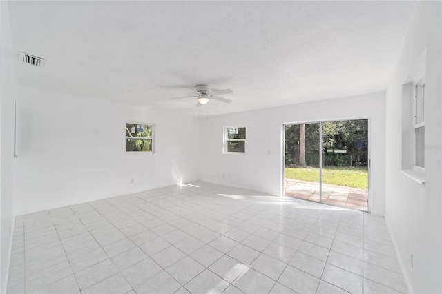 unfurnished room featuring light tile patterned flooring and a healthy amount of sunlight