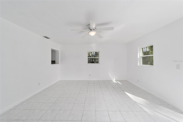 spare room featuring ceiling fan and light tile patterned flooring