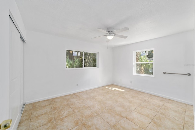 spare room featuring ceiling fan and a textured ceiling