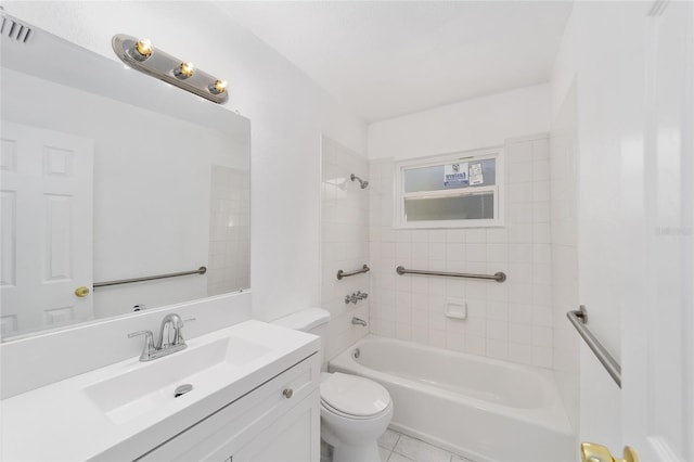 full bathroom featuring tiled shower / bath, vanity, toilet, and tile patterned floors