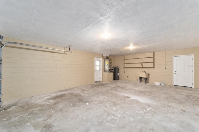 garage with electric water heater, heating unit, and sink