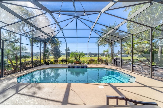 view of pool with a patio and glass enclosure