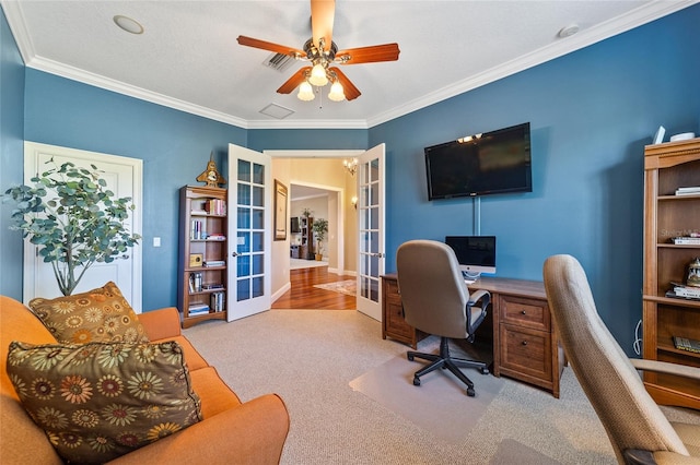 home office featuring french doors, ceiling fan, ornamental molding, and light colored carpet