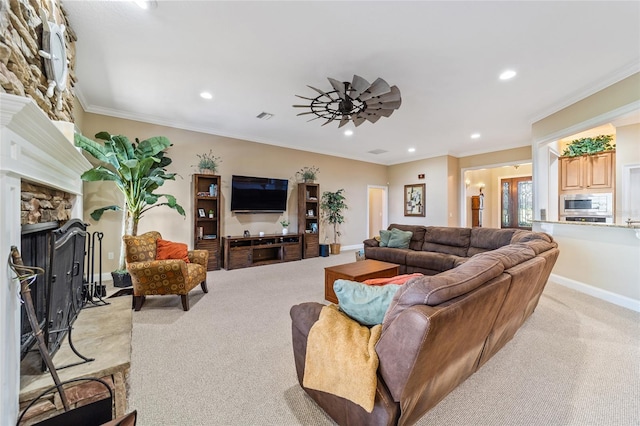 living room with ornamental molding, light carpet, a stone fireplace, and ceiling fan