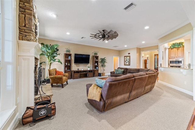 carpeted living room featuring ornamental molding and ceiling fan