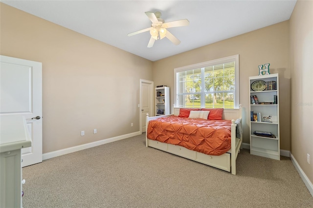 bedroom with ceiling fan and light carpet