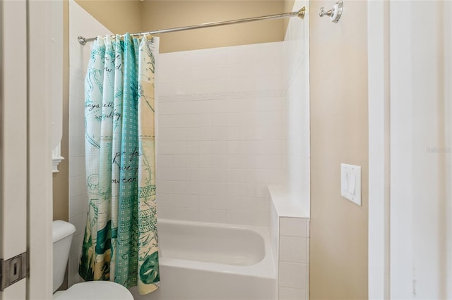 bathroom featuring shower / bath combo and toilet