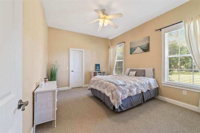 bedroom with multiple windows, carpet floors, and ceiling fan