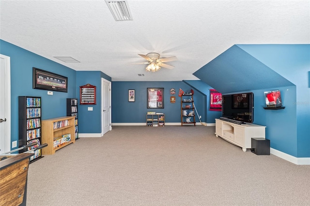 rec room with a textured ceiling, carpet flooring, and ceiling fan