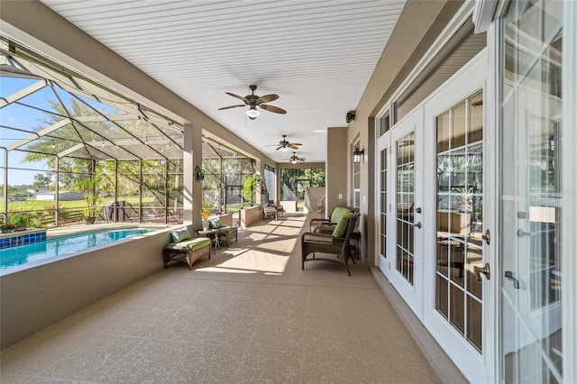 sunroom with french doors, ceiling fan, and a swimming pool