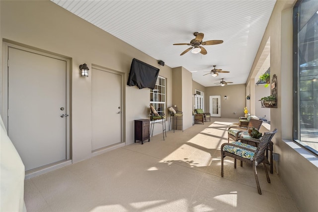 sunroom / solarium featuring ceiling fan