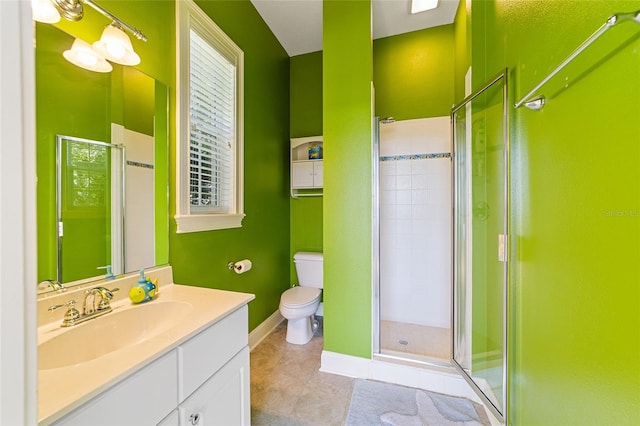 bathroom featuring toilet, tile patterned flooring, vanity, and a shower with door