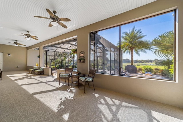 unfurnished sunroom with ceiling fan