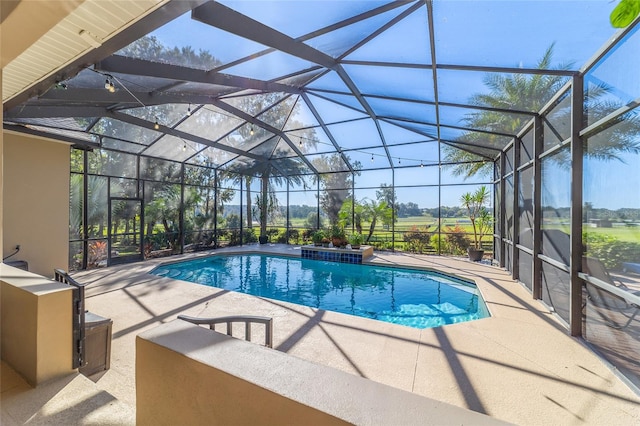 view of swimming pool featuring a patio and a lanai