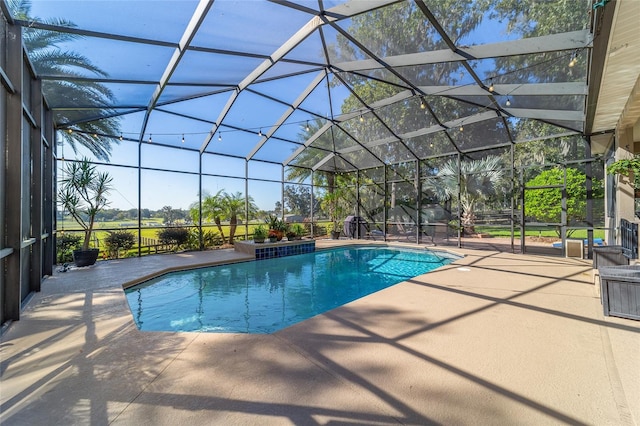 view of pool featuring a patio and glass enclosure