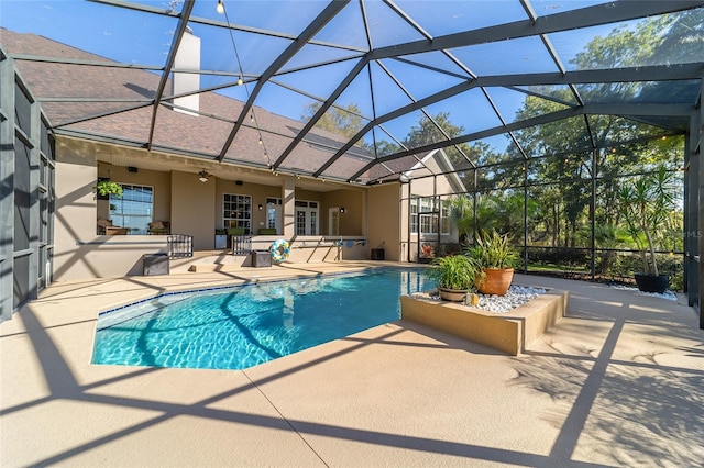 view of swimming pool with a patio area, a lanai, and ceiling fan