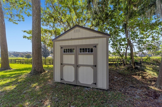 view of outdoor structure with a yard and a rural view