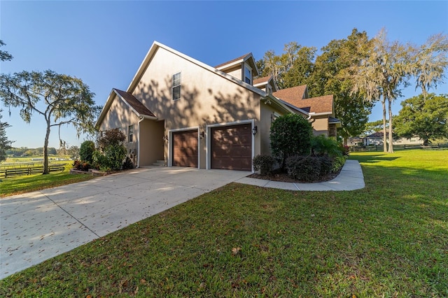 view of front of property with a front yard and a garage