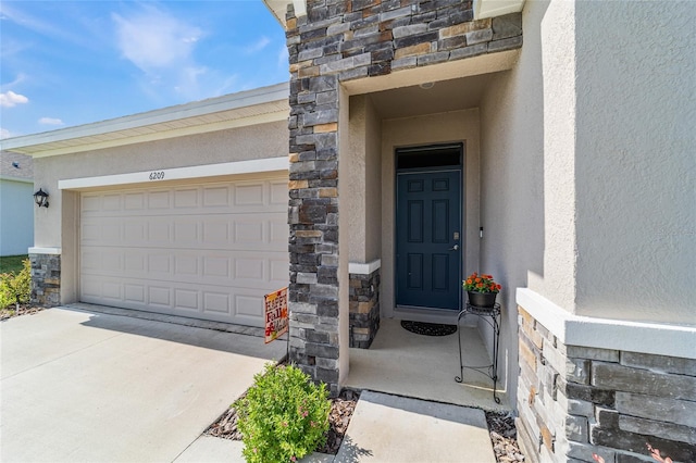 view of exterior entry with a garage