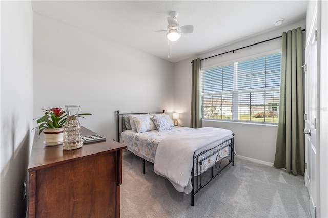 bedroom featuring ceiling fan and light carpet