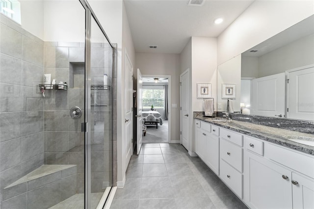 bathroom with ceiling fan, tile patterned floors, an enclosed shower, and vanity