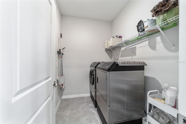 laundry room featuring light tile patterned floors and washer and dryer