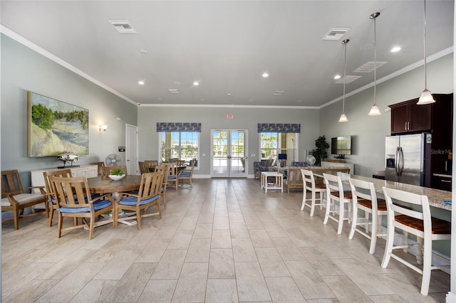 dining area featuring ornamental molding and french doors