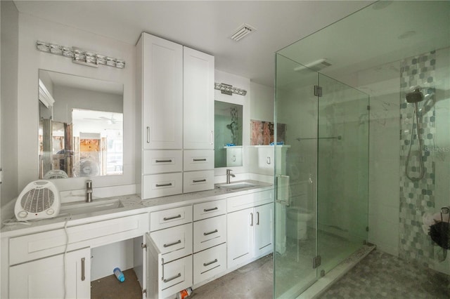 bathroom featuring vanity and a shower with door