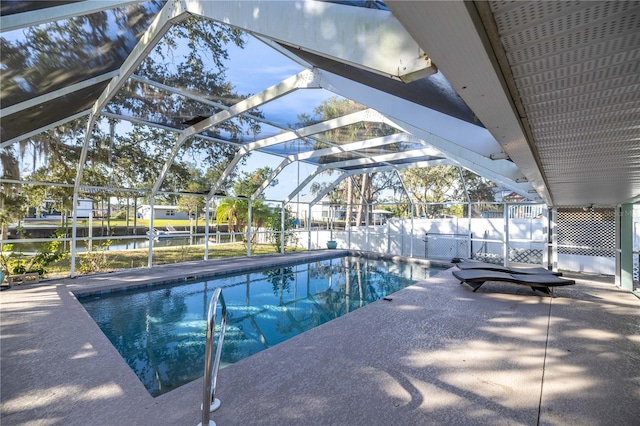 view of swimming pool featuring a water view, glass enclosure, and a patio