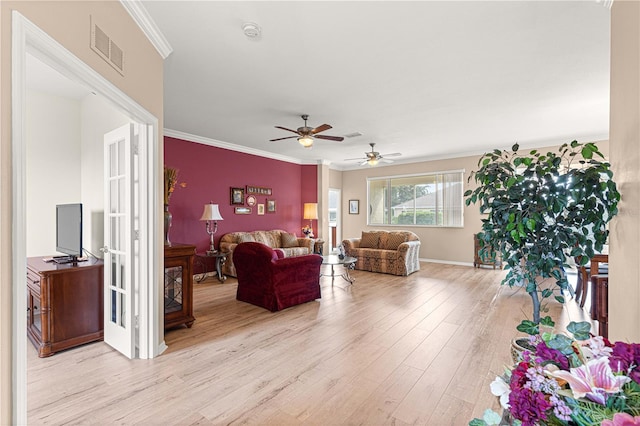 living room with ceiling fan, ornamental molding, and light hardwood / wood-style flooring