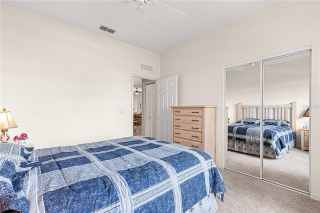 carpeted bedroom with a ceiling fan, a closet, and visible vents